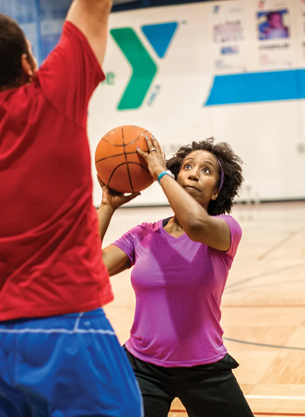 adult woman shooting basketball