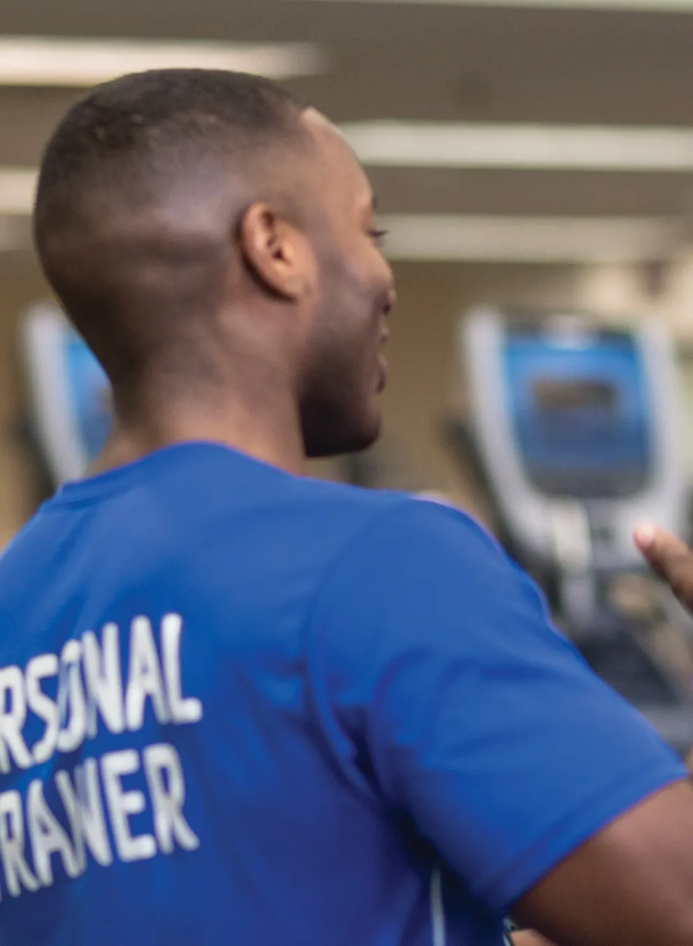 personal trainer helping female client