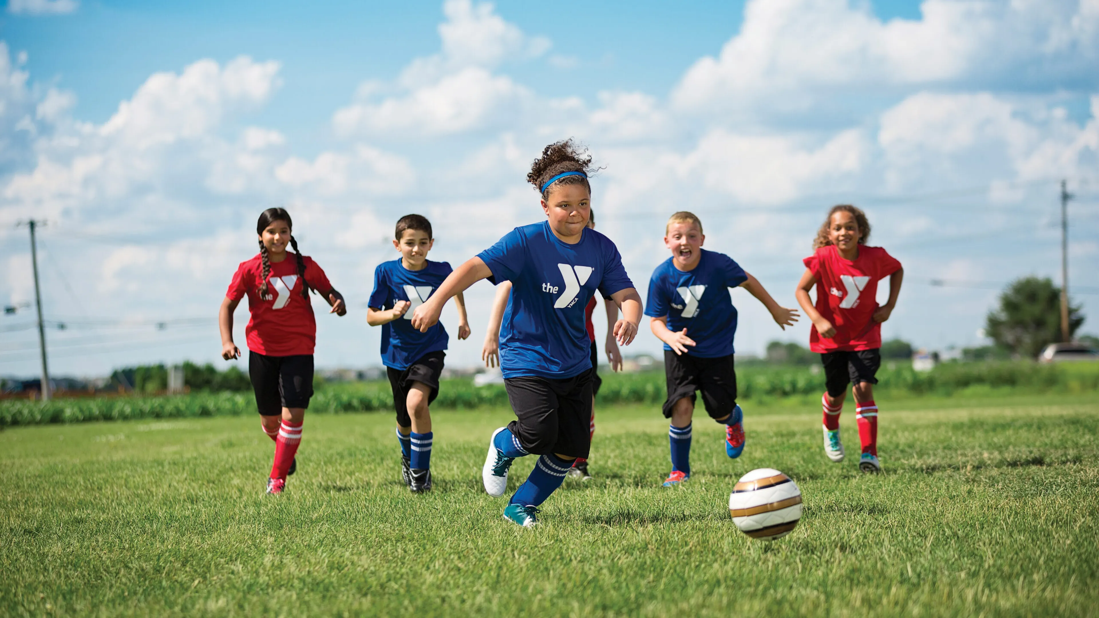 girl kicking soccer ball