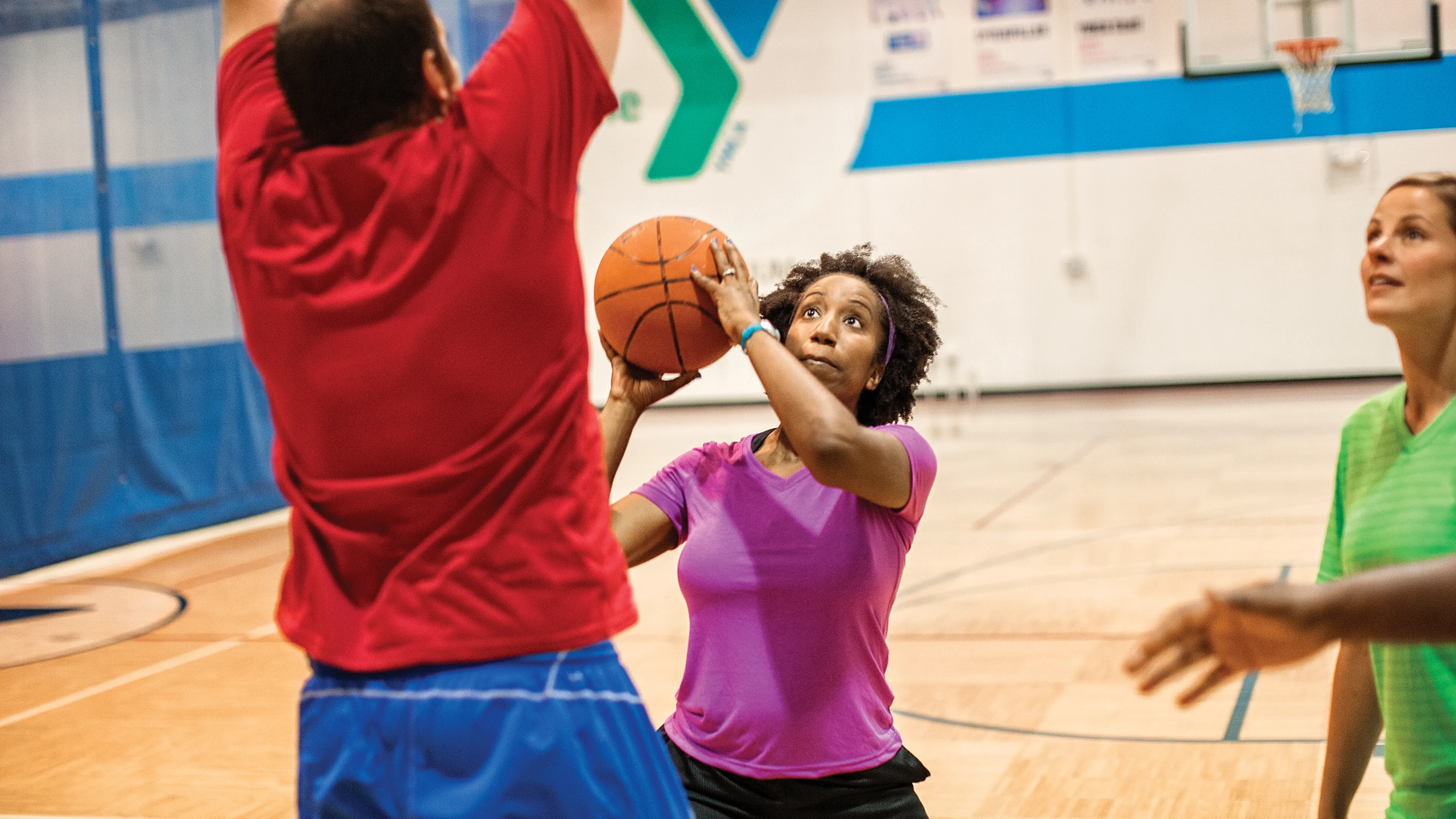 adult woman shooting basketball