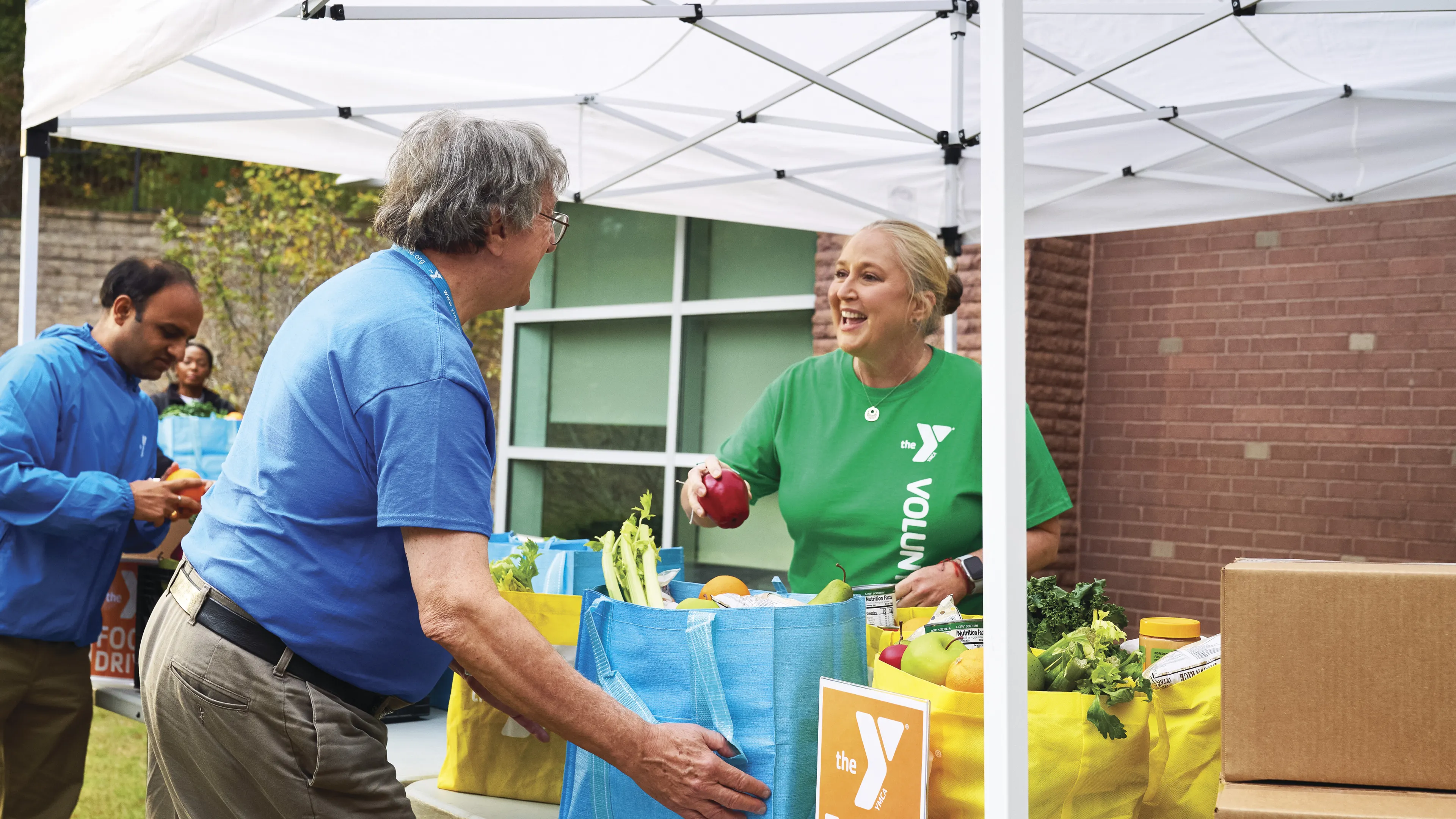 Women handing out food for the community.