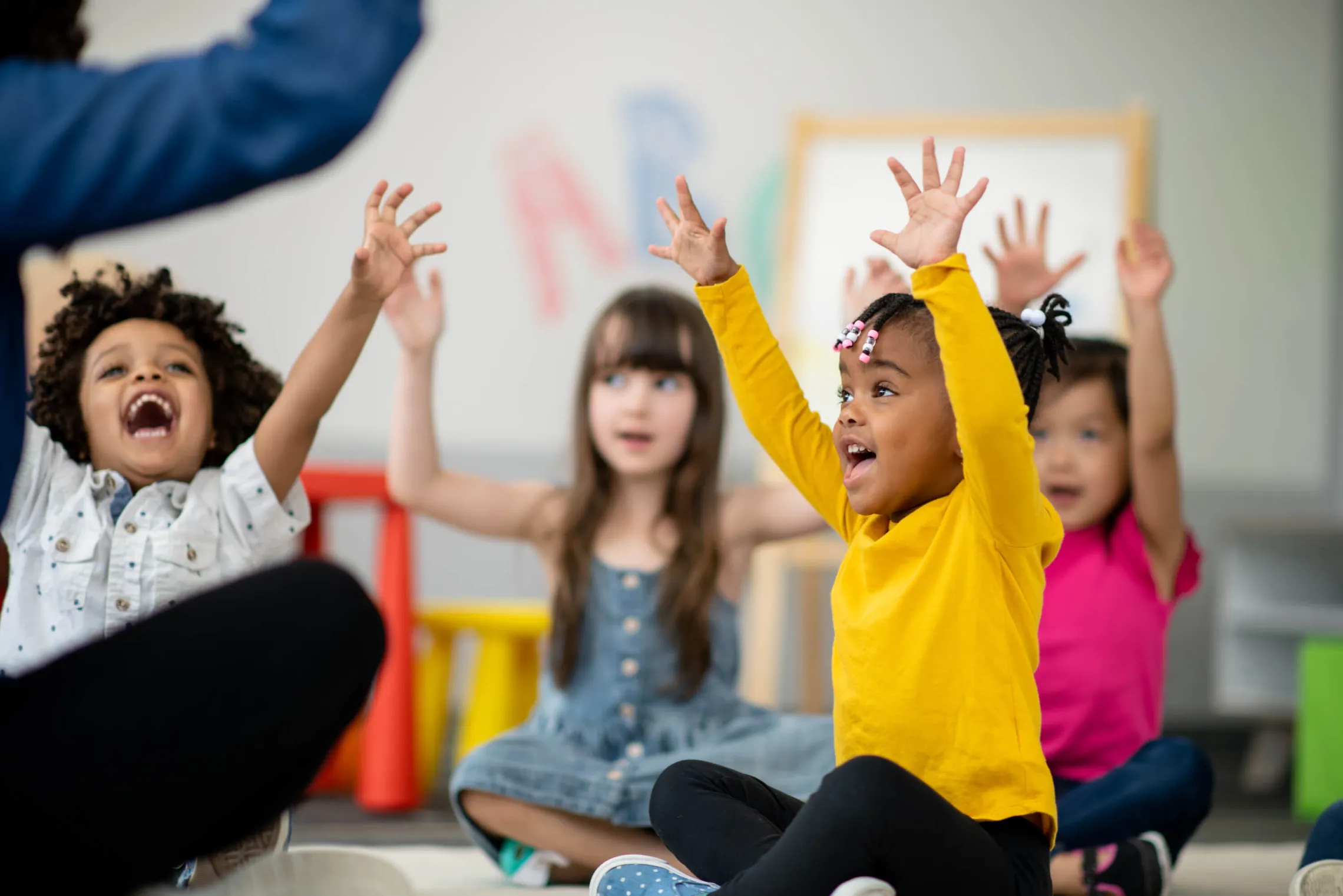 children raising hands having fun