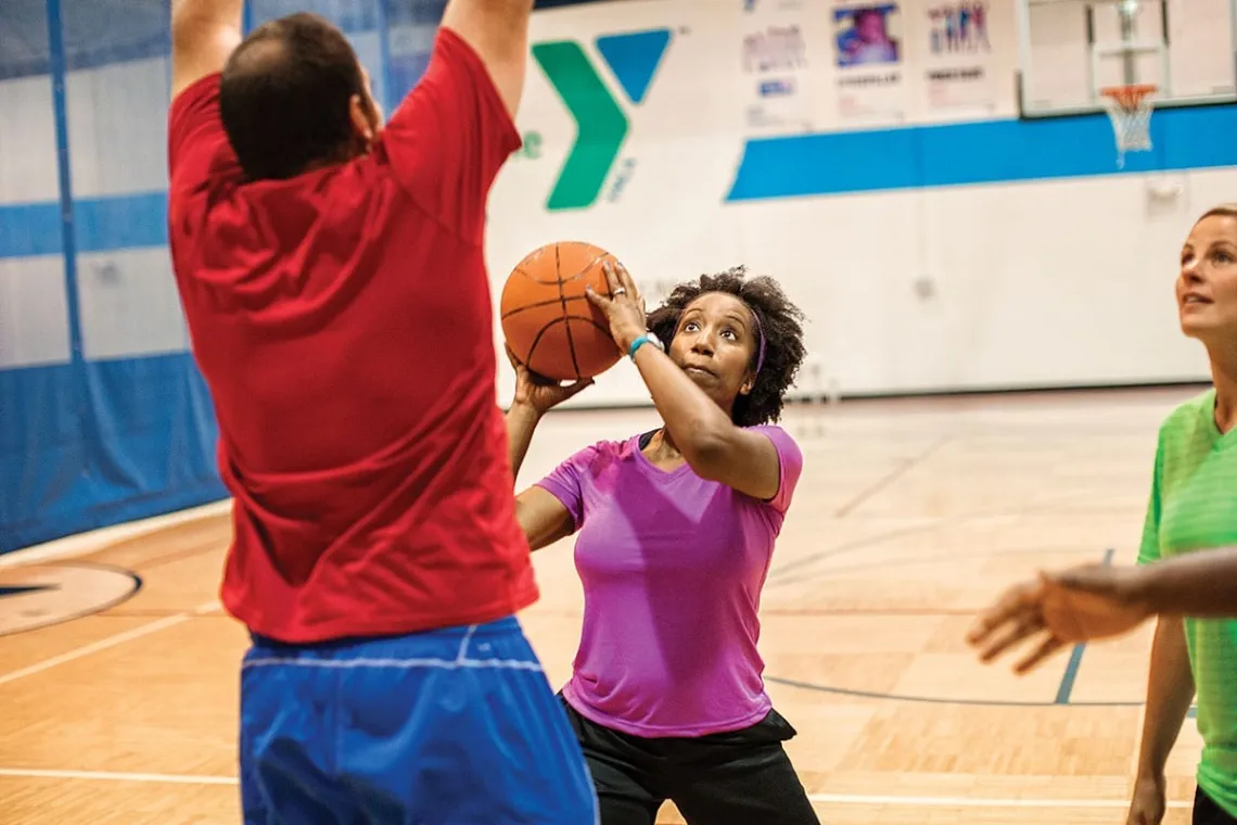 adult woman shooting a basketball