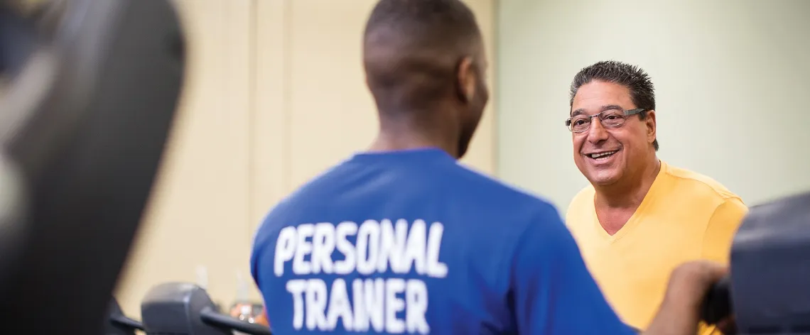 trainer training a man on treadmill