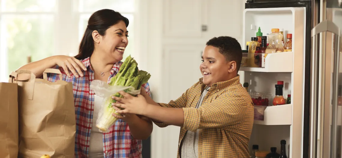 mother and son unloading healthy groceries