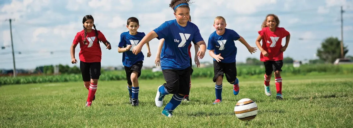 girl kicking soccer ball