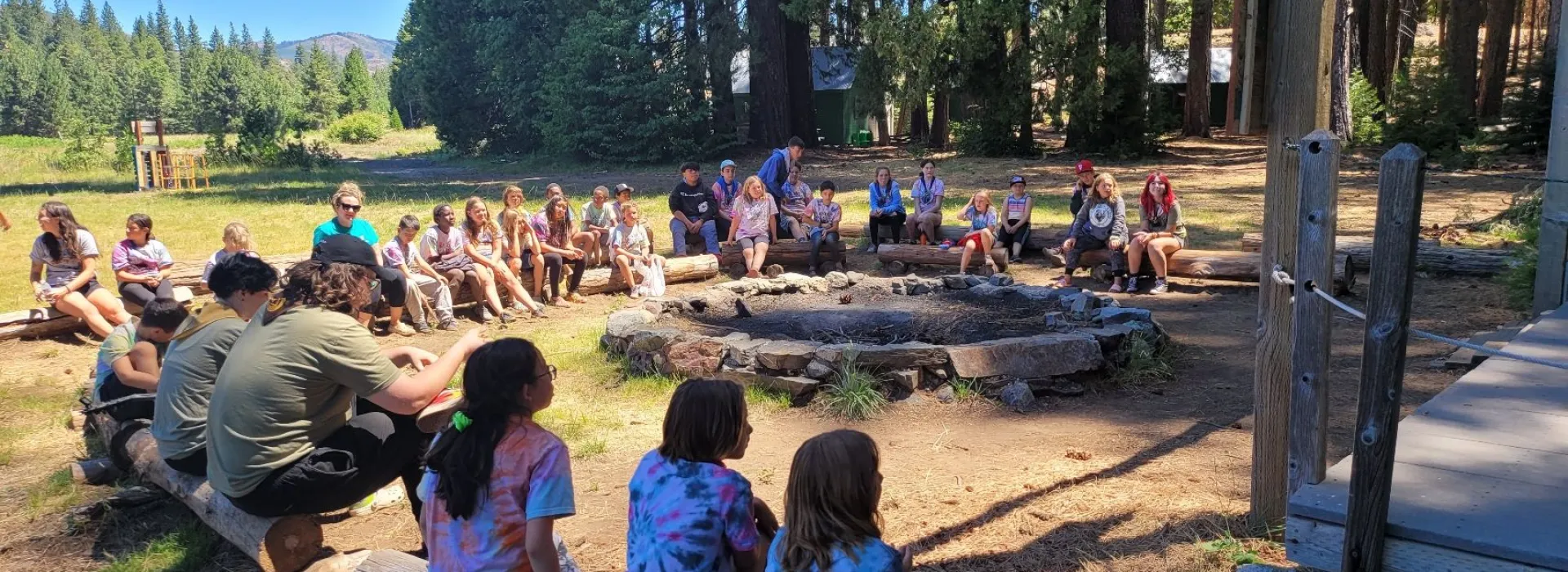 kids sitting around a fireplace daytime